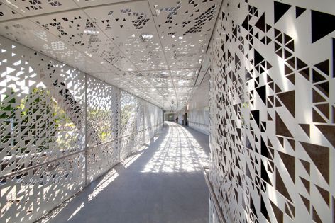 Oatley Station, located in Sydney, features a light-filled perforated metal footbridge with a striking geometric design by Arrow Metal.